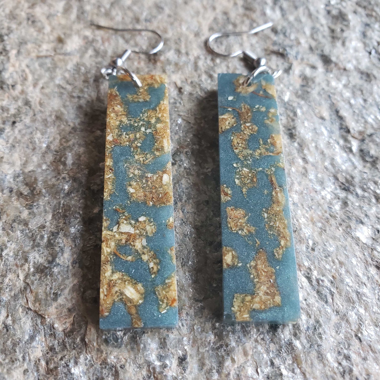 Boho dangle earrings with blue and gold pattern made from dried jasmine flowers