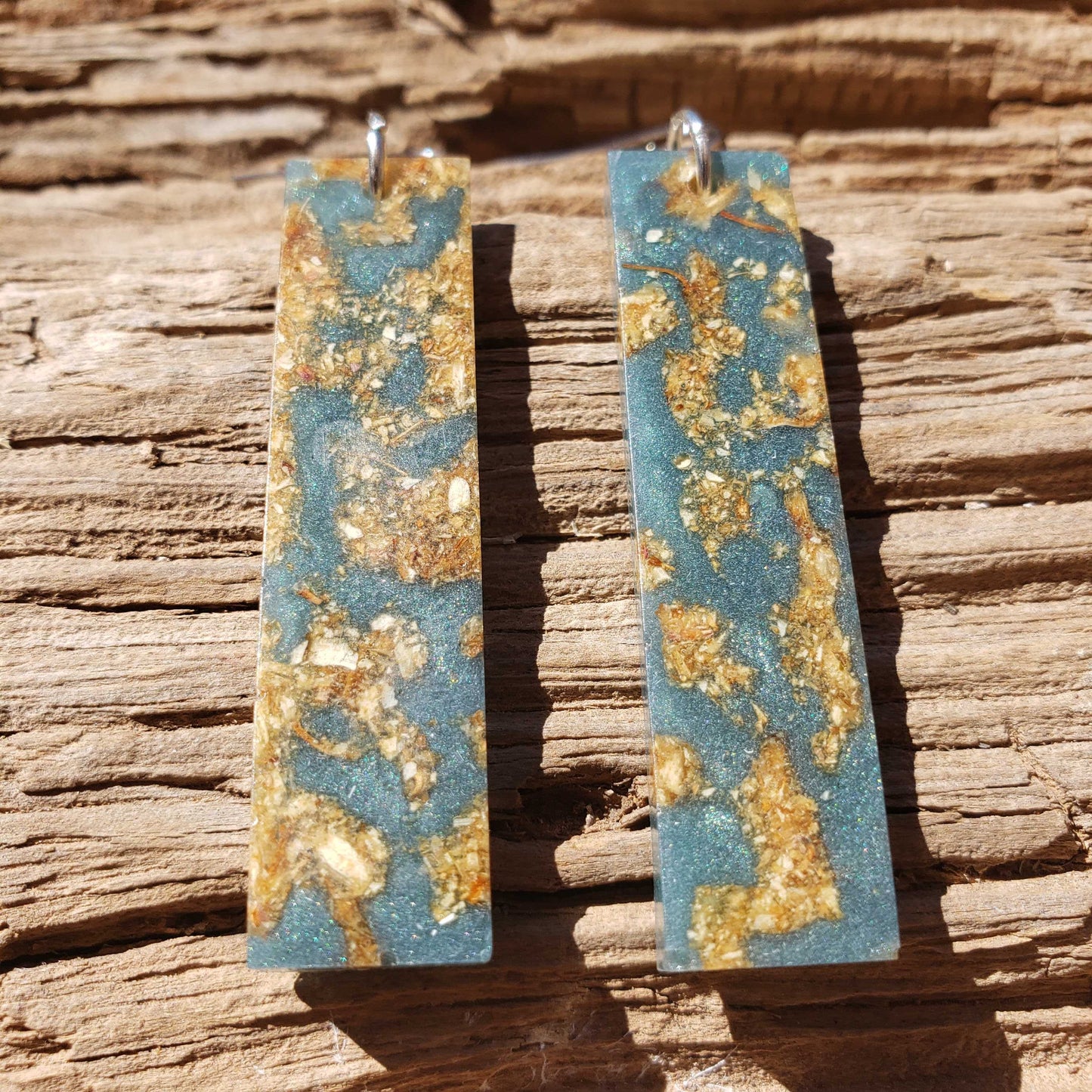 Boho dangle earrings with blue and gold pattern made from dried jasmine flowers
