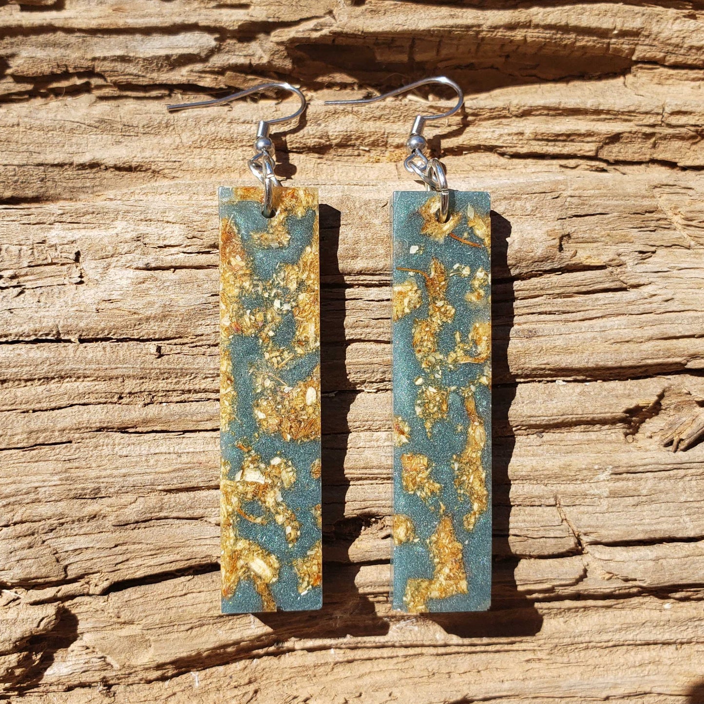 Boho dangle earrings with blue and gold pattern made from dried jasmine flowers