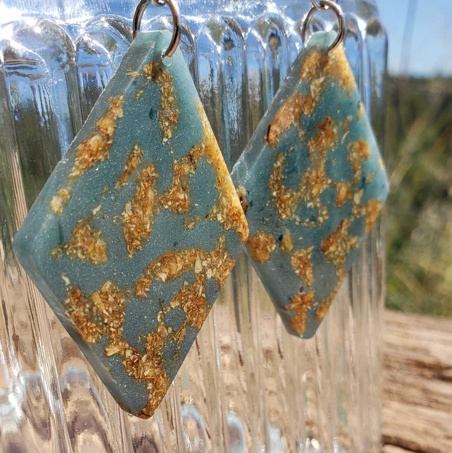 Boho teal and gold patterned earrings with dried flowers