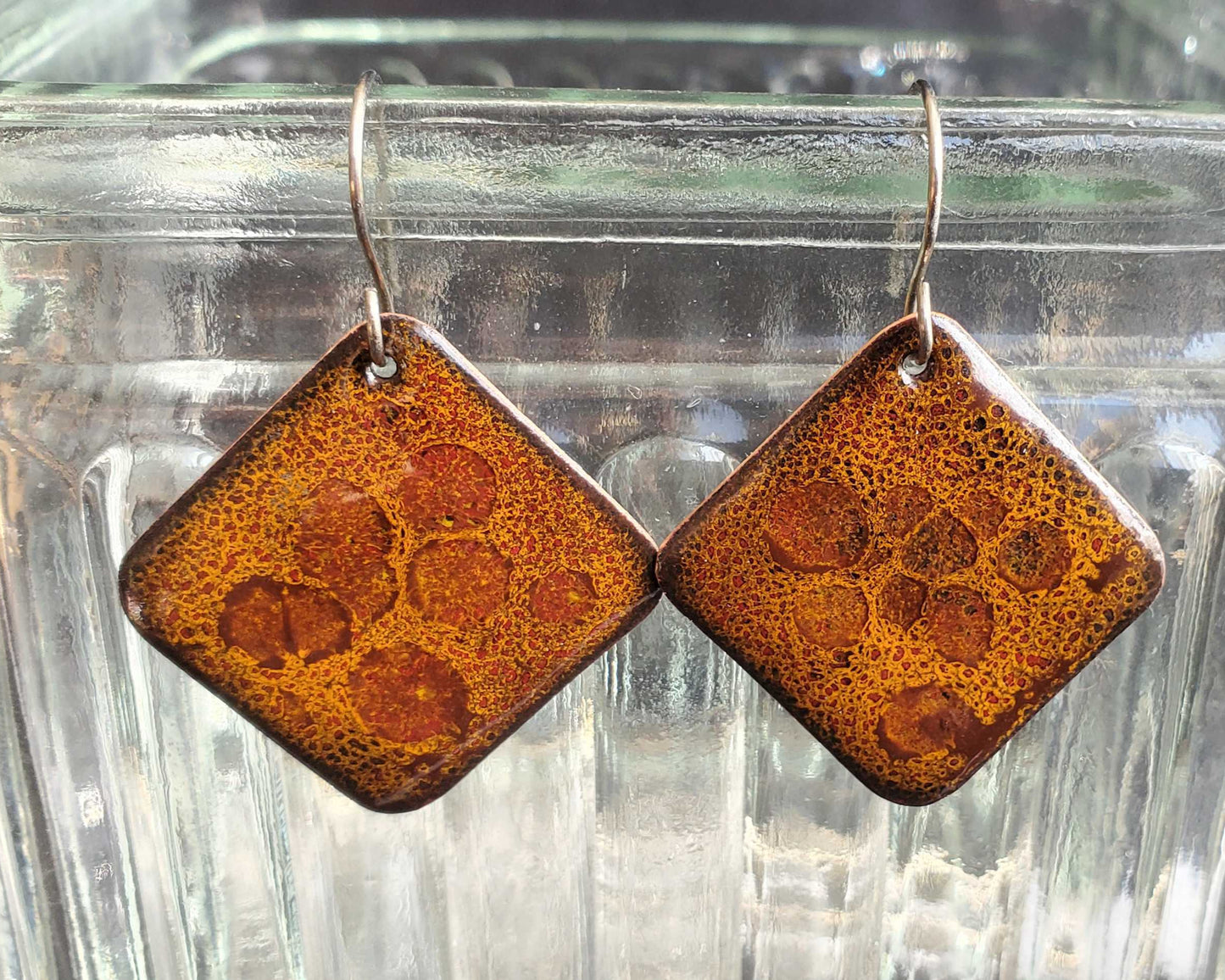 Pair of square copper and glass earrings with a rust-like color