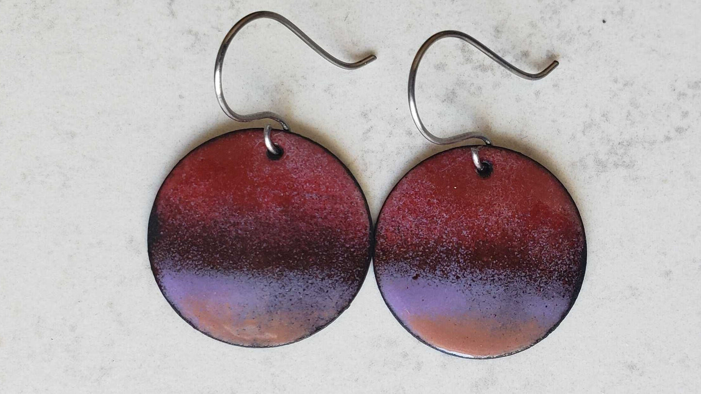 Round copper earrings with a gradient design on a light gray background