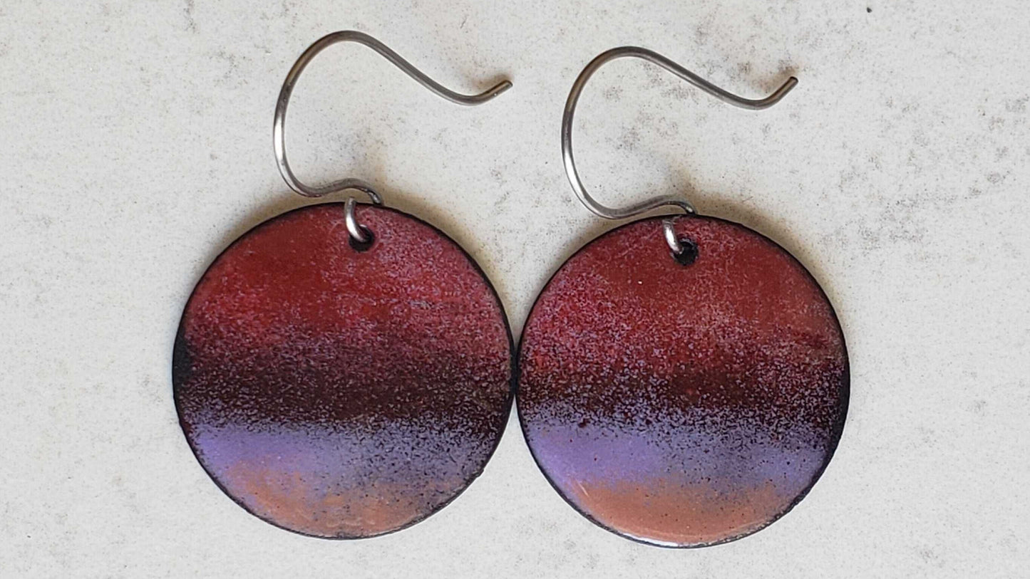 Round copper earrings with a gradient design on a light gray background