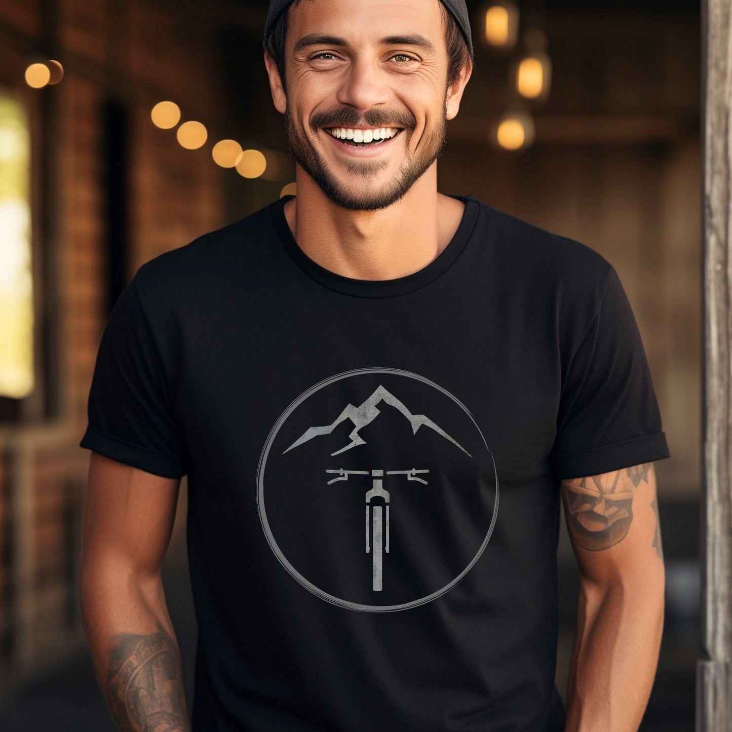 Man wearing a black t-shirt with a mountain and bike graphic
