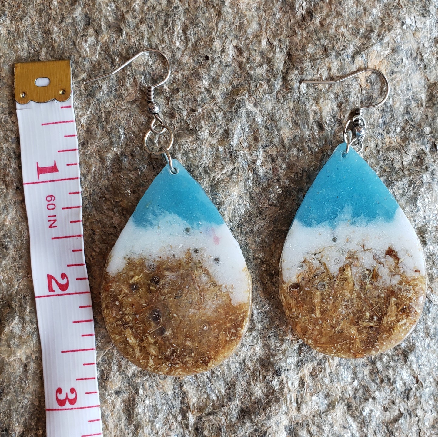 Teardrop-shaped earrings with blue, white, and brown gradient