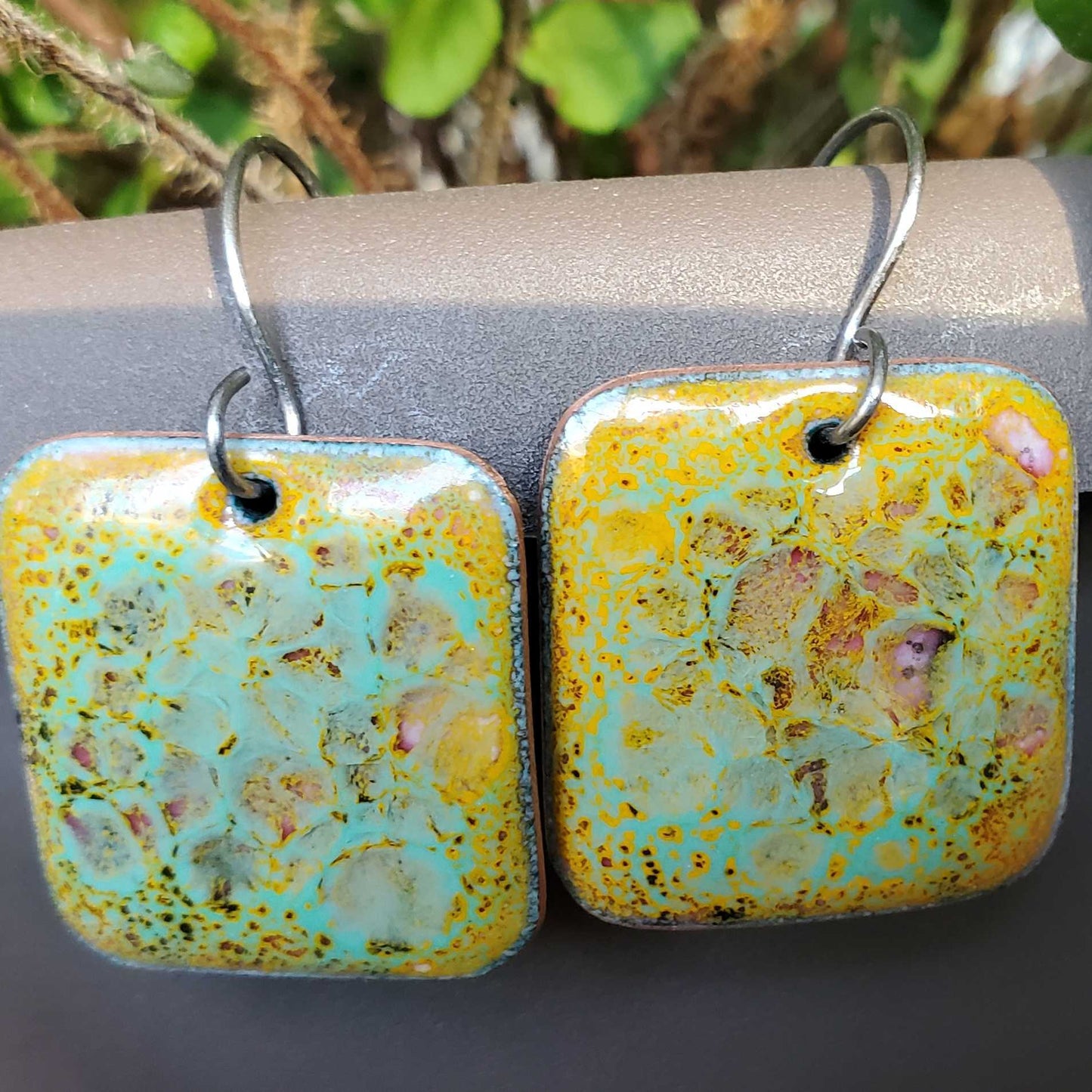 Yellow and turquoise copper enamel earrings with various colors shining through