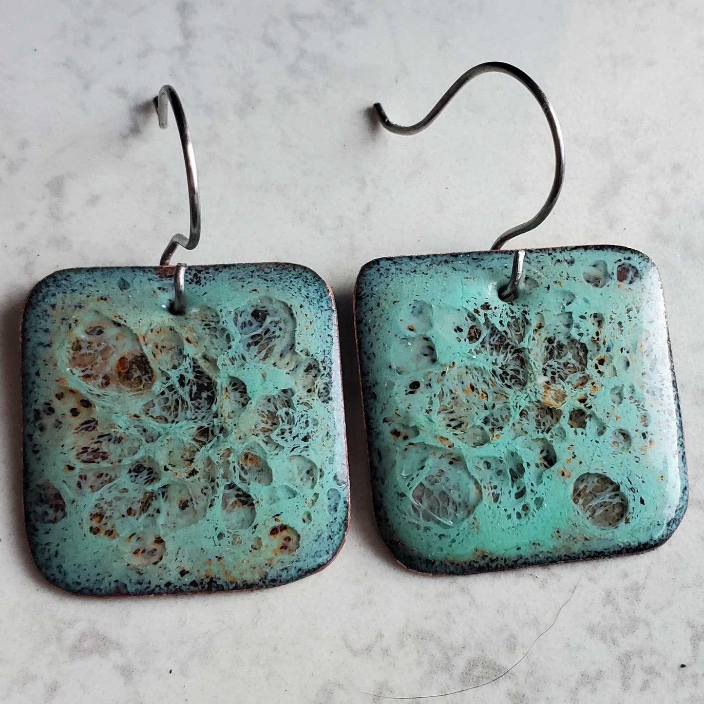 Pair of square copper and glass earrings with textured turquoise surface