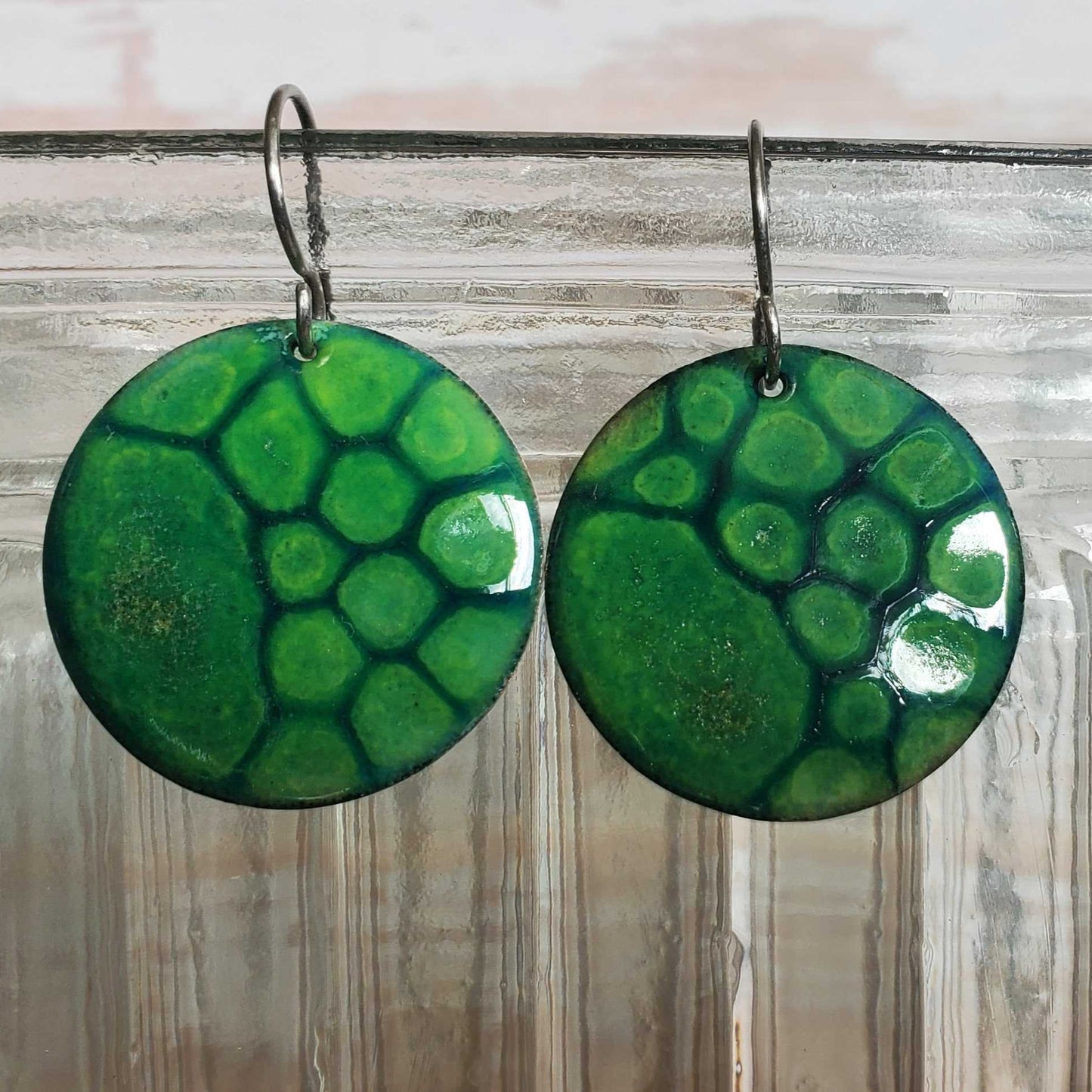 Green copper enamel earrings with a turtle shell design