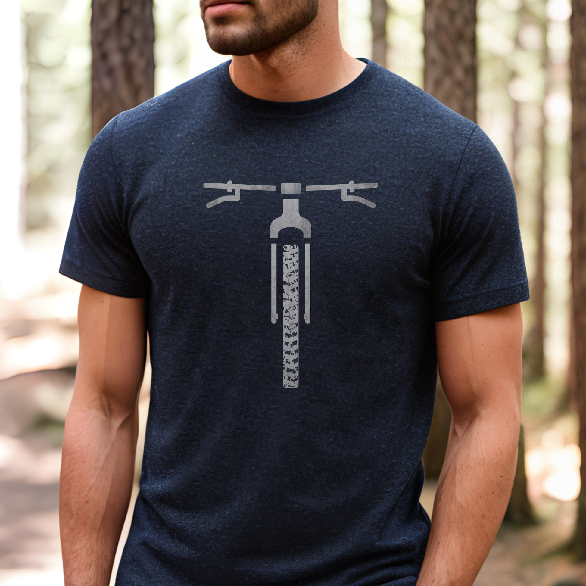 Gray t-shirt with mountain and bicycle graphic worn by a person outdoors