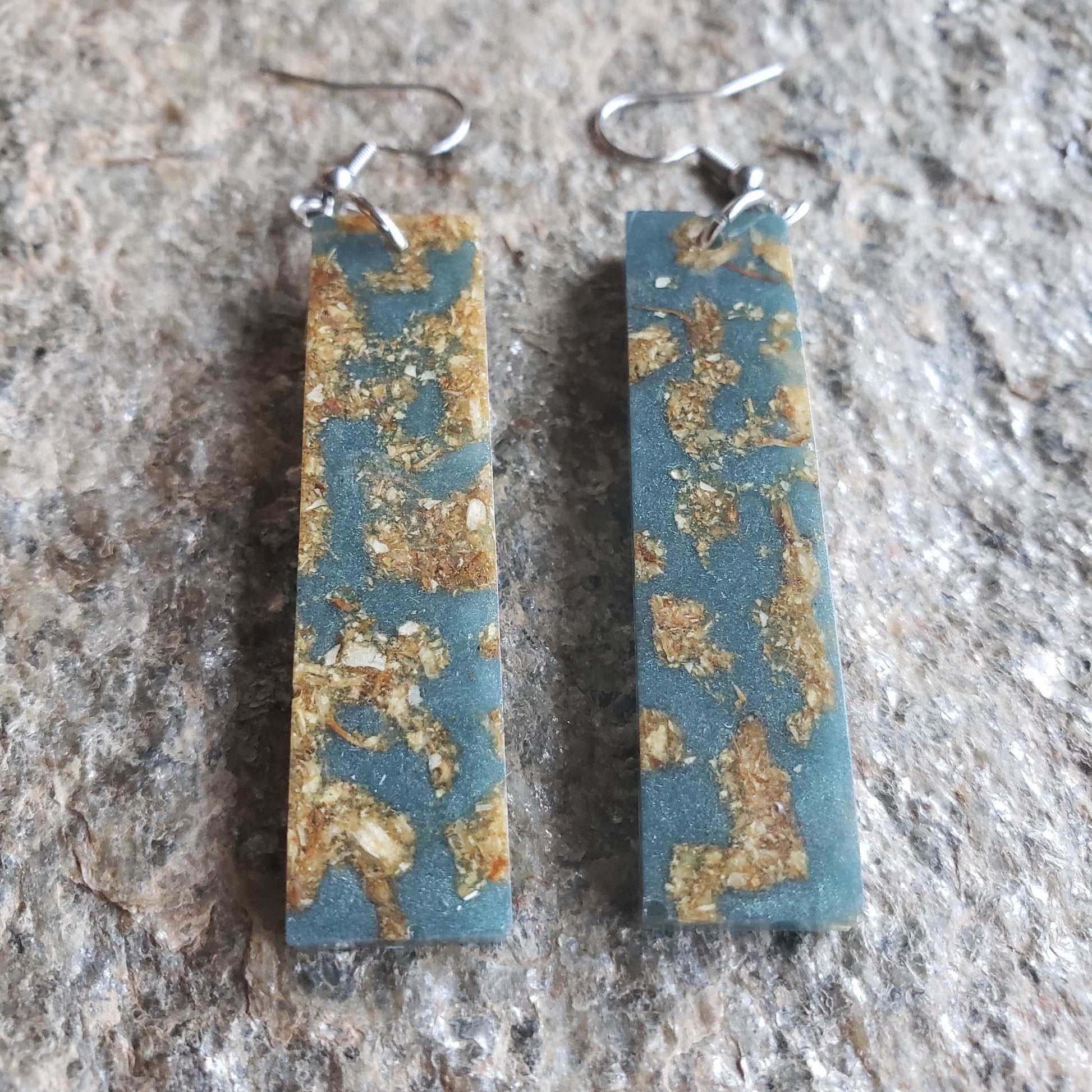 Boho dangle earrings with blue and gold pattern made from dried jasmine flowers