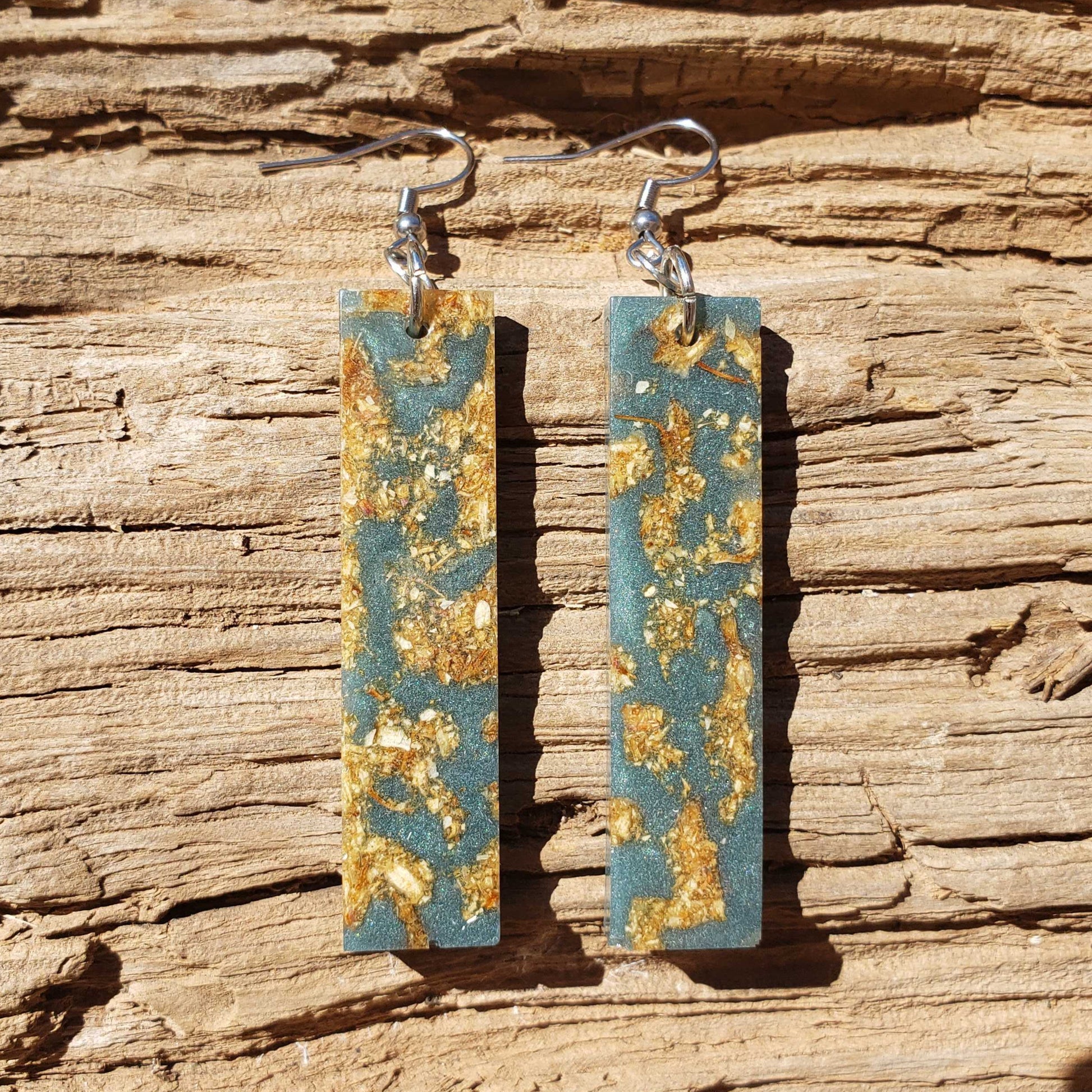 Boho dangle earrings with blue and gold pattern made from dried jasmine flowers