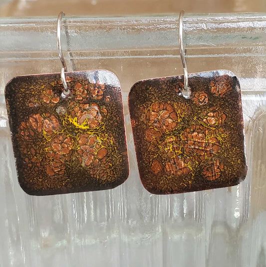 Square copper enamel earrings with a textured brown and pink and yellow crackle pattern design