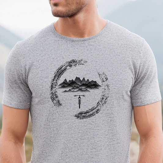 Gray t-shirt with mountain and bicycle graphic worn by a person outdoors
