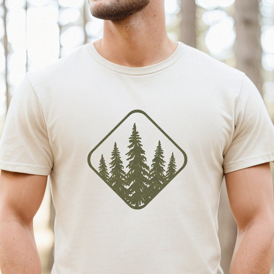 Man in nature wearing a beige t-shirt with a green forest graphic