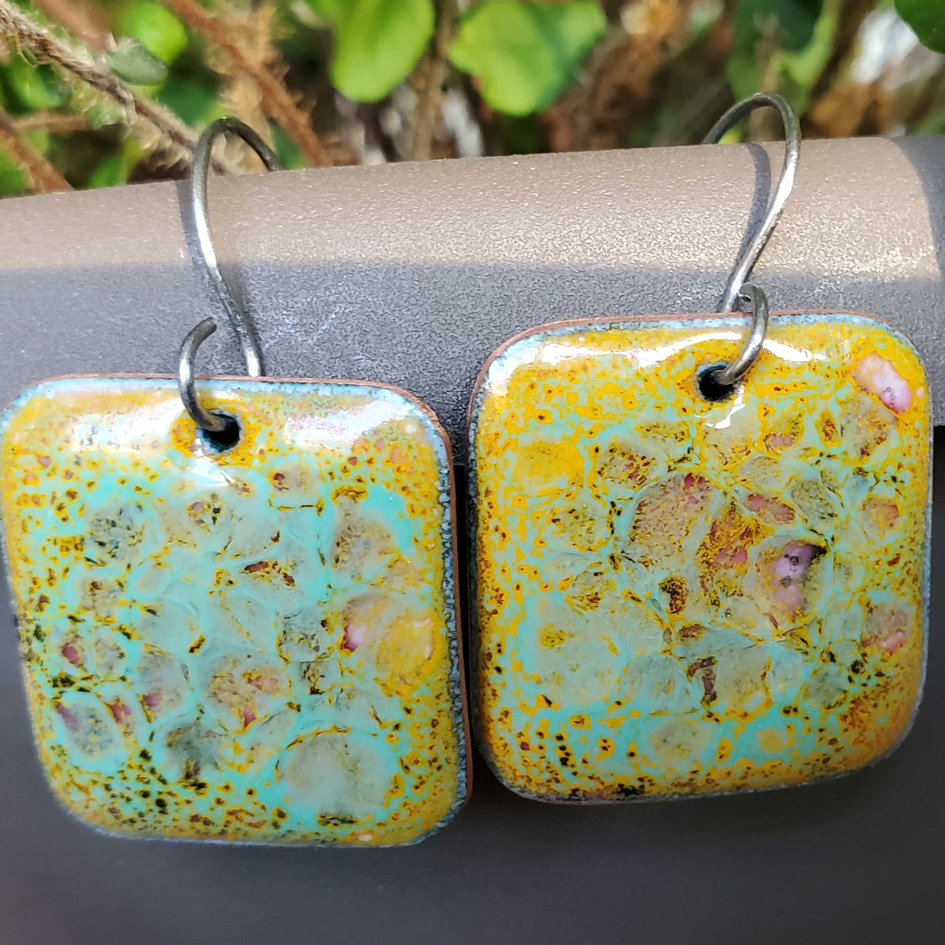 Yellow and turquoise copper enamel earrings with various colors shining through