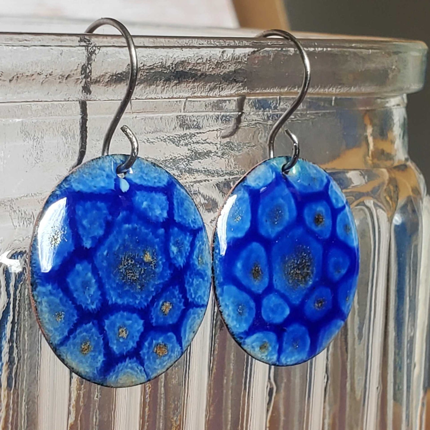 Blue copper enamel earrings with a mandala like design